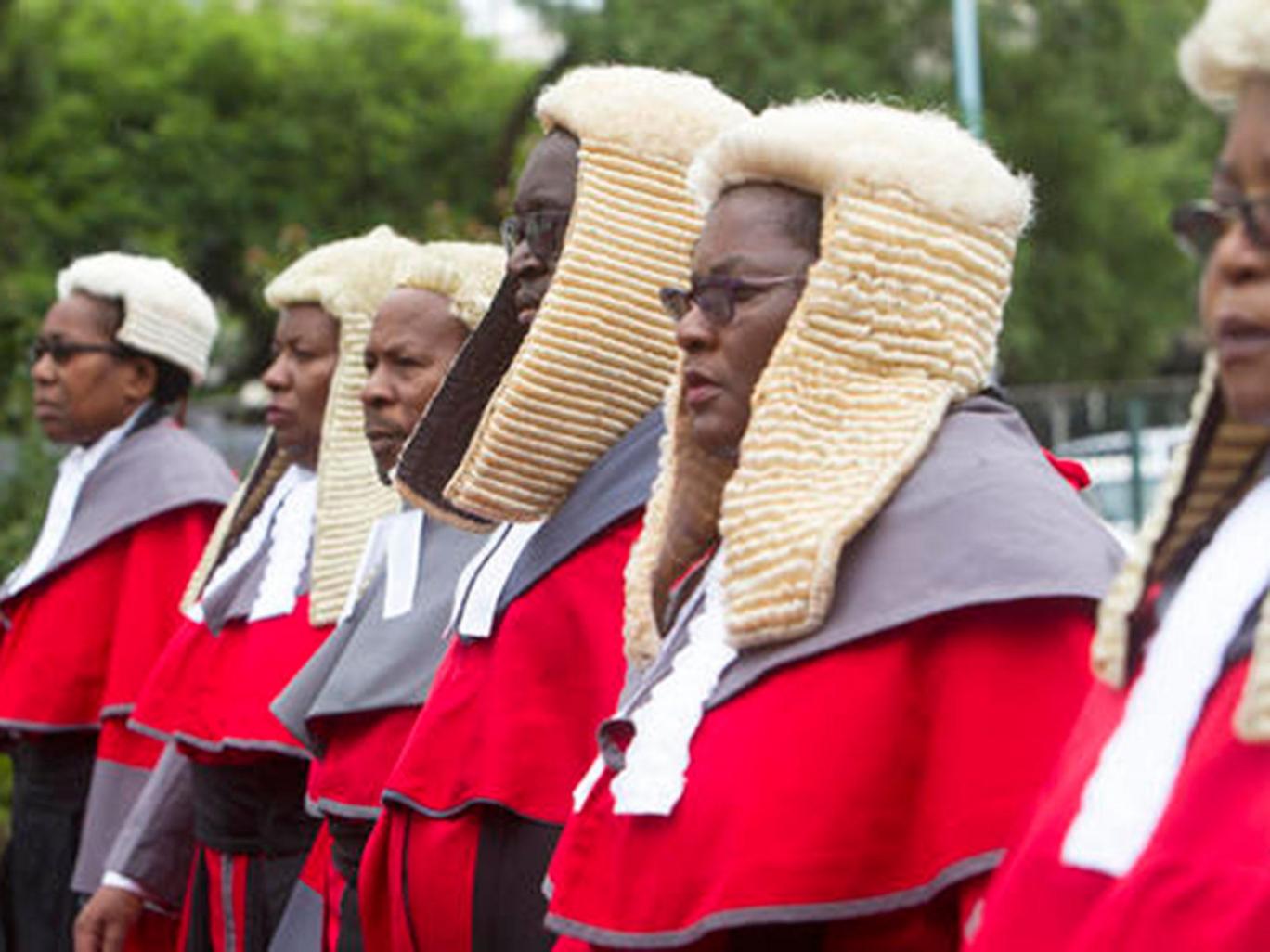 Zimbabwean judges in long red robes and horsehair wigs, a throwback to an era of British Colonial rule